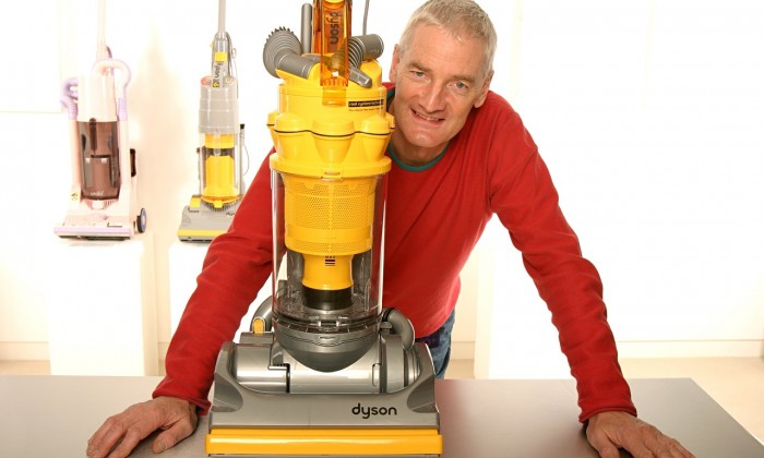 James Dyson with a Dyson vacuum cleaner