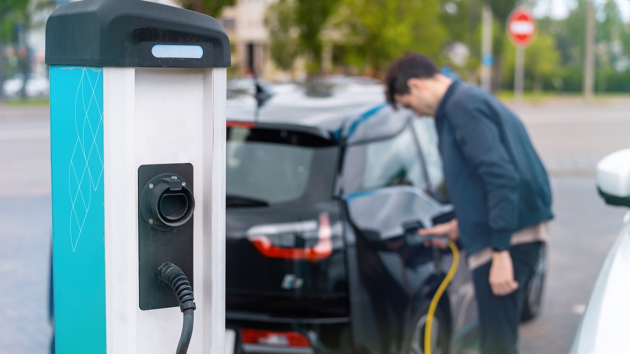 Man charging electric car